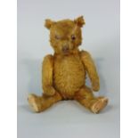 Vintage teddy bear with glass eyes, stitched nose and paws, pronounced muzzle, articulating limbs,