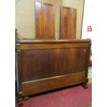 A 19th century mahogany bateau li, double bedstead, the scrolled and moulded rails with carved