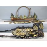 A collection of antique horse brasses, many presented as martingales, together with a further