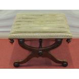 A Regency mahogany X frame centre stool with applied floral bosses and upholstered top