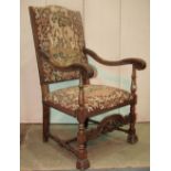 Two similar late 19th century open armchairs in a Carolean style with floral, fruit and figural
