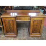 A small Victorian mahogany inverted breakfront pedestal sideboard, the doors with well matched