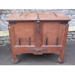 A substantial Indian teakwood coffer, with panelled frame work and iron clad banding, raised on four