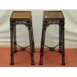 A pair of Chippendale style mahogany urn stands of square cut form, with tapering cluster column