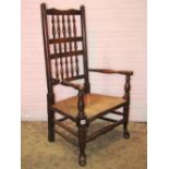 A Lancashire style low rush seated open elbow chair with turned spindleback, together with a pair of