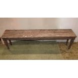 A Victorian weathered oak hall bench with plank seat, carved border and frieze, with mask and