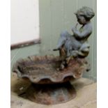 A small weathered cast iron bird bath in the form of a shell, with raised figure surmount, 40cm