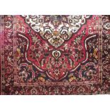 Full pile hand woven Persian Bakta carpet, traditional decoration, red ground, 320 x 210cm