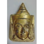 A cast gilt bronze mask in the form of an eastern deity, 16cm