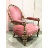A Victorian drawing room chair, with upholstered seat, arm pads, and cameo shaped back within a