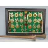 A felt pin board decorated with a collection of various horse brasses, brushes and bells together
