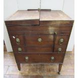A George III mahogany gentleman's washstand with foldover top, revealing a comprehensively divided