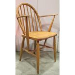 A vintage Ercol hoop and stick back open elbow chair, principally in beechwood