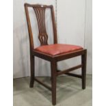 A set of four Georgian style mahogany dining chairs with combed splats over drop in upholstered