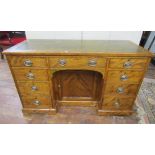 A 19th century satin walnut kneehole writing desk, fitted with nine drawers, to the recess a