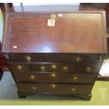 An 18th century oak bureau, the fall flap enclosing the original stepped interior, with drawers