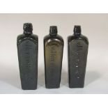 Three mid-19th century olive green Dutch gin bottles, coffin shape with applied V. Hoytema & Co