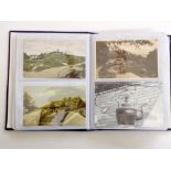 An album containing a quantity of black and white and colour topographical postcards of the local