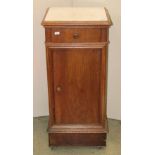 A 19th century continental walnut veneered bedside cupboard of square cut form with inset marble top