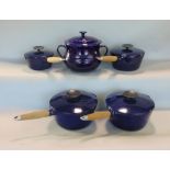 Le Creuset ceramic twin handled casserole pot, together with four graduated navy blue enamel