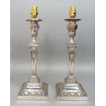 Pair of silver plated candlesticks converted into electrical lamps, on square tapered columns,