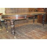 A mid Victorian period mahogany D end extending dining table fitted with three additional leaves