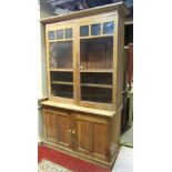 Early 20th century scrubbed oak two tier school house cupboard, the lower section enclosed by two