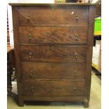 An oak bedroom chest of five long drawers with brass pear drop handles