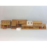 Collection of handmade model wooden buildings on a wild west theme including long two storey