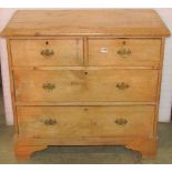 An Edwardian stripped pine bedroom chest of two long and two short drawers raised on bracket feet