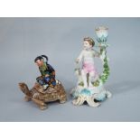 A candlestick in the 18th century Chelsea manner with applied figure of a cherub and floral garland,