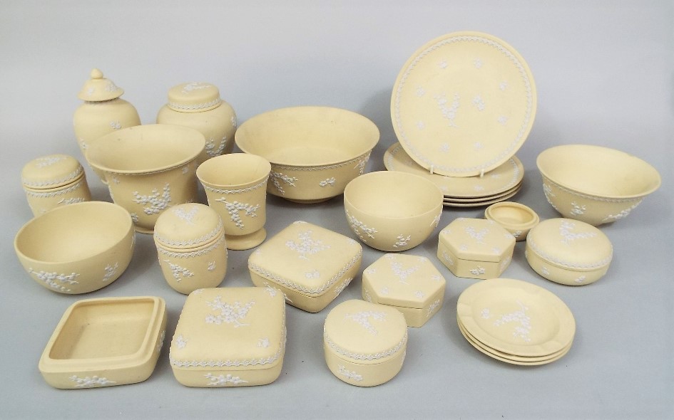 A collection of Wedgwood Jasperwares with prunus decoration on a pale primrose coloured ground