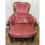A late Regency drawing room chair, with scrolled arms on turned supports and rosewood finish