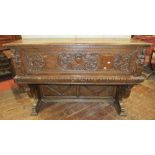 An early Italian walnut cassone with rising lid and fall front, raised on an open framework, with