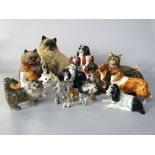 A collection of ceramic cats and dogs including a pair of 19th century Staffordshire spaniels with