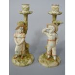A pair of Victorian Royal Worcester candlesticks by James Hadley, both in the form of tree trunks