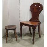 A Victorian mahogany hall chair, the shield shape back with carved acanthus detail over a solid seat