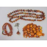 Collection of amber coloured jewellery; two bead necklaces, quantity of oval beads and a stylised