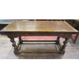 An Old English style oak refectory table, the heavy plank top with cleated ends, raised on four
