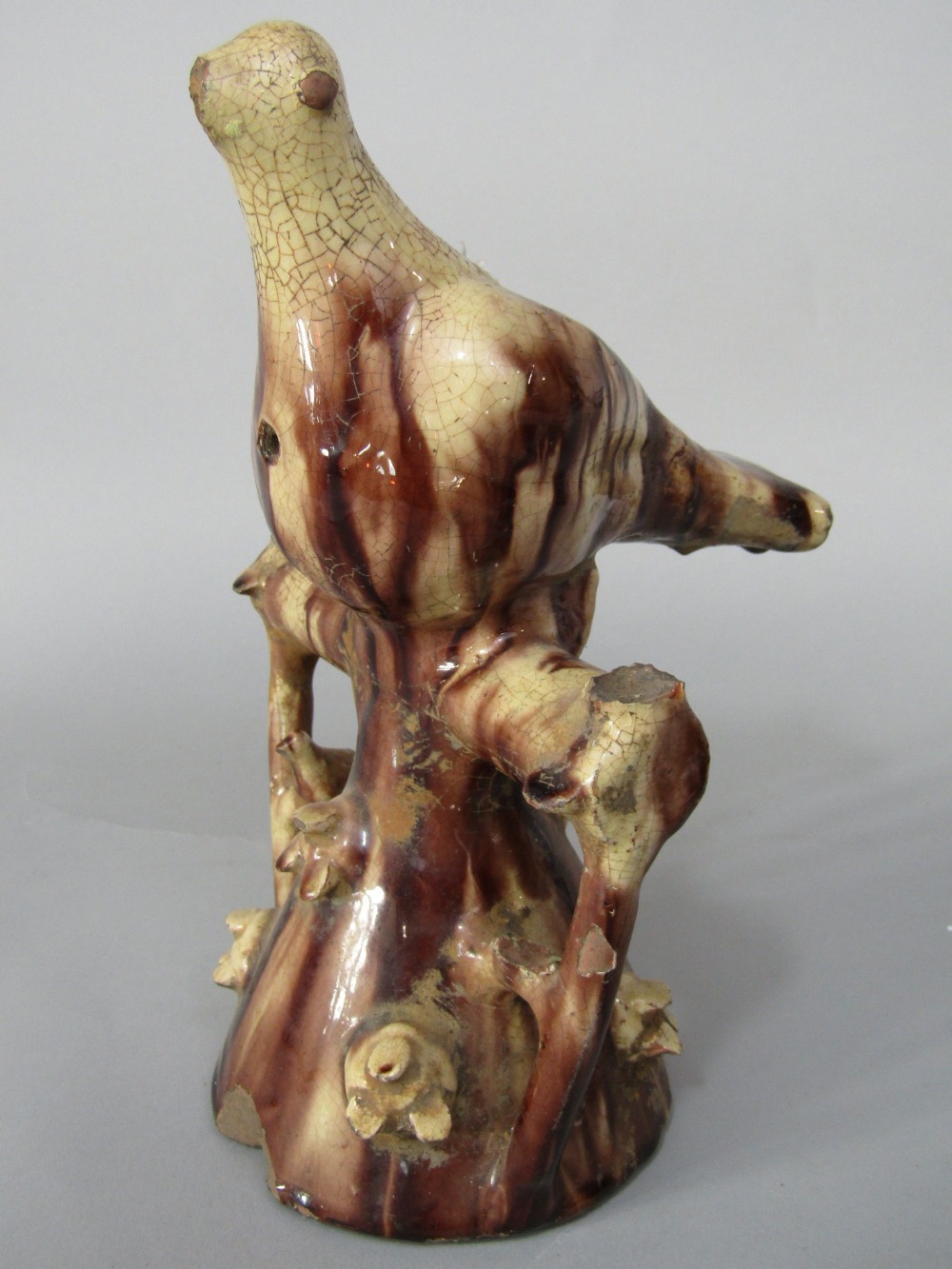 An unusual 19th century slipware pottery model of a bird/whistle with streaked brown and cream