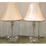 A pair of good quality contemporary glass table lamps, with faceted stems and square stepped