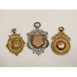 Two 9ct medal fobs, 12.3g total and a further silver and gold example (3)