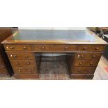 A mid-19th century walnut veneered pedestal writing desk, fitted with nine drawers, the inset top