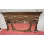 A Regency period gilded overmantle mirror, with urn floral swag and other detail, 155cm long x