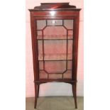 An inlaid Edwardian mahogany display cabinet with box wood stringing, freestanding and enclosed by