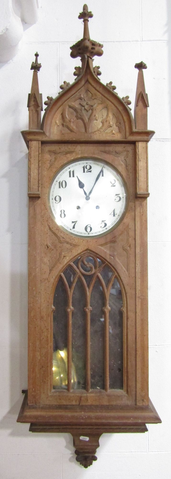 Arts and crafts satin walnut drop dial wall clock in the ecclesiastical manner, the silvered dial