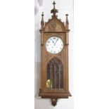 Arts and crafts satin walnut drop dial wall clock in the ecclesiastical manner, the silvered dial