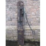 A 19th century iron work water pump with long handle mounted on a wooden board