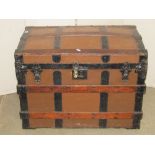 A Victorian timber lathe and steel reinforced, dome top travelling trunk with side carrying handles