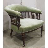 A late Victorian tub chair with upholstered seat and low horseshoe shaped back with slender vertical